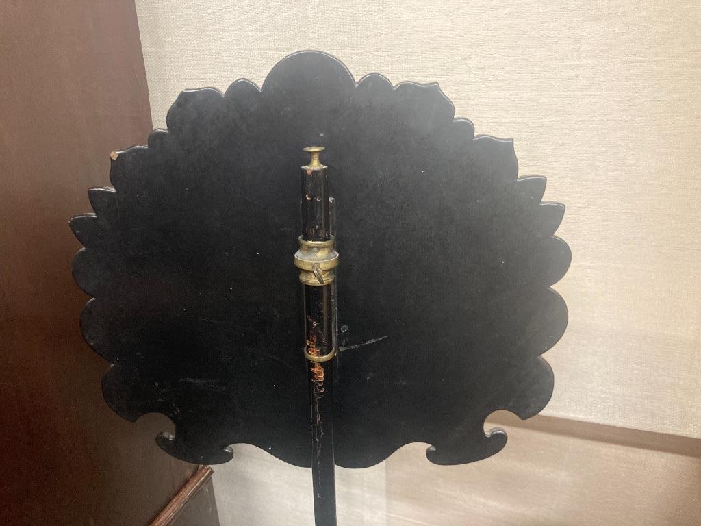 A Victorian ebonised pole screen with papier mache banner, height 130cm